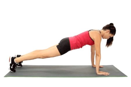 woman doing plank on yoga mat